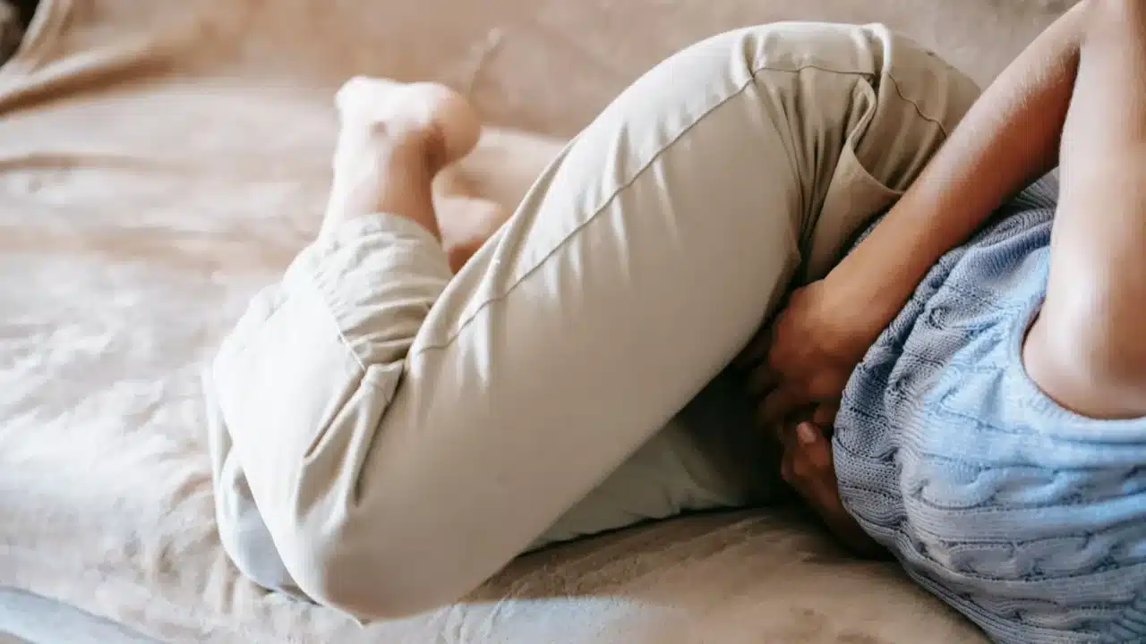 Posisi Tidur Melancarkan Haid: Panduan Lengkap & Tips 4 Woman Holding Stomach Pain Relief Hot Compress